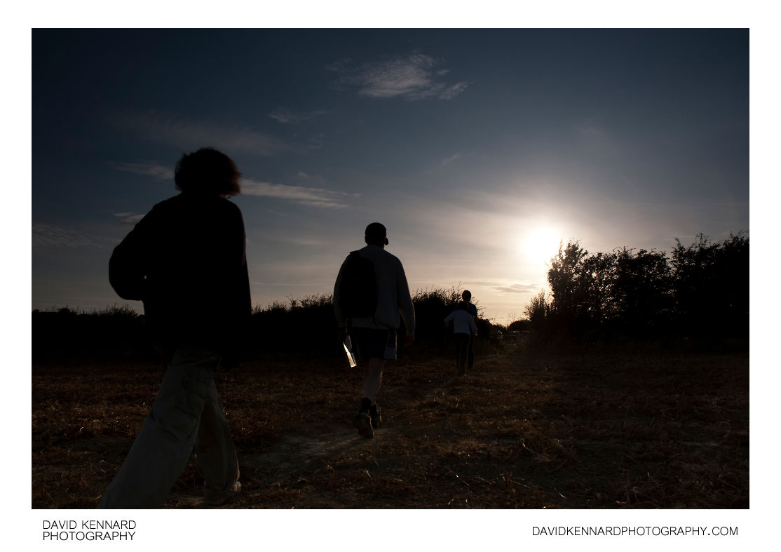Silhouette of family walking through field