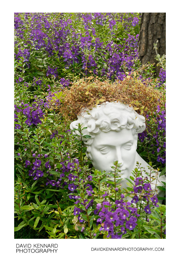 Greek bust in flowers