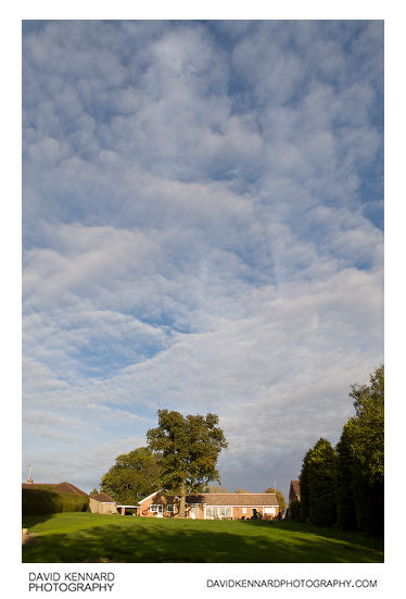 Thin clouds above house