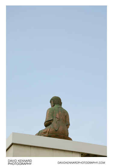 Buddha sits on building