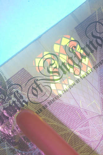Visible light photo of a British £20 bank note with UV induced fluorescence lit using Convoy S2+ Nicha 365nm UV torch with glass protector removed
