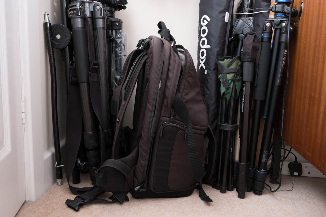 Tripods, camera bag, light modifiers etc. stored by resting them up against wall