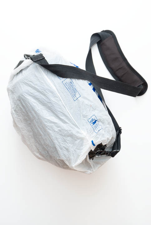 Camera bag covered with plastic bag rain cover