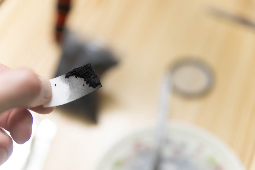 Small amount of carbon powder on a piece cut from an old milk bottle