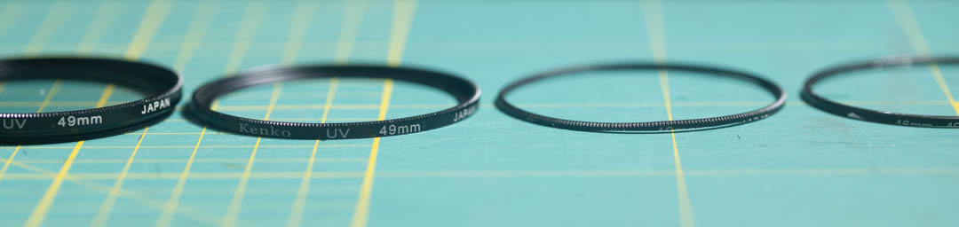 Left to right: Slim filter; Slim filter with rear shaved down to middle ring; Slim filter shaved down to front threads only; Front threads cut from 46-49mm step up ring