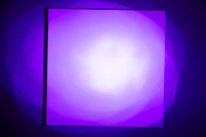 Visible light photo of PTFE on card, lit by old cheap UV flashlight