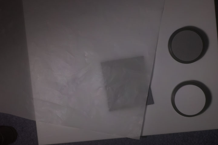 0.1mm thick PTFE sheet over piece of brown cardboard backing