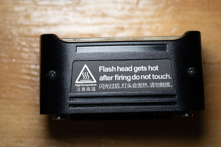 AD200 Pro standard flash head showing the screw either side of it that must be unscrewed to open up the head
