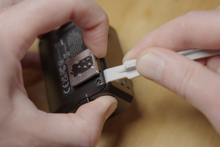 Separating the base of the Godox IT30 Pro flash by working round it with a spudger