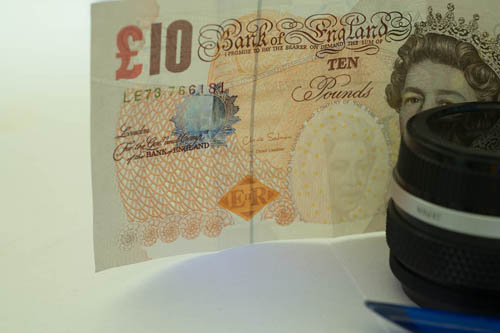 Photo of a British £10 note, barely showing the UV security feature. Lit by cheap Waterproof Outdoor 380-400nM UV Ultra Violet LED Flashlight Light Torch Lamp with 330WB70 Excite Fluorescence filter
